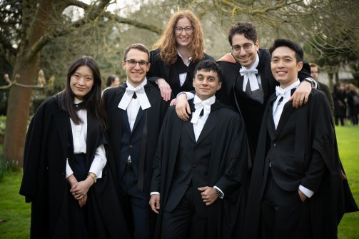Six individuals stand together at the graduation celebrations at Ǻ, on Saturday 23 March 2024